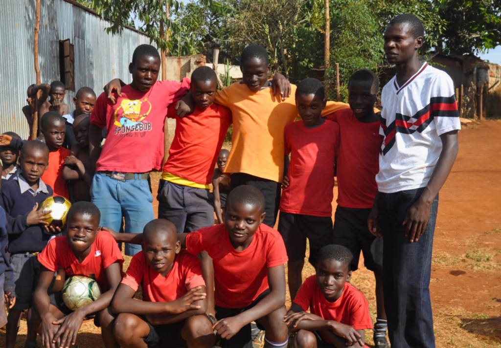 Kenyan children's soccer team with coach